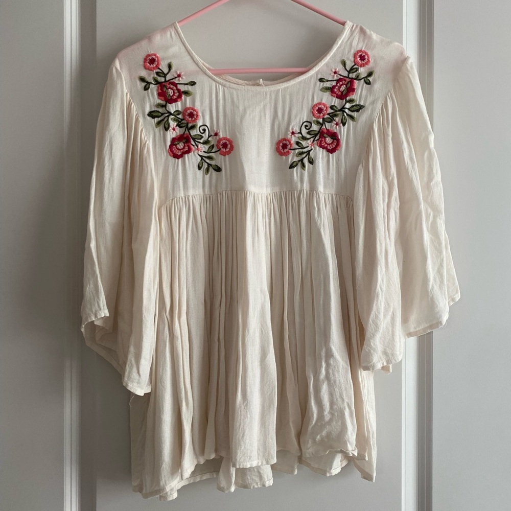 Off-white flowy blouse with floral embroidered design